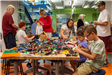 Group of People Building with Legos